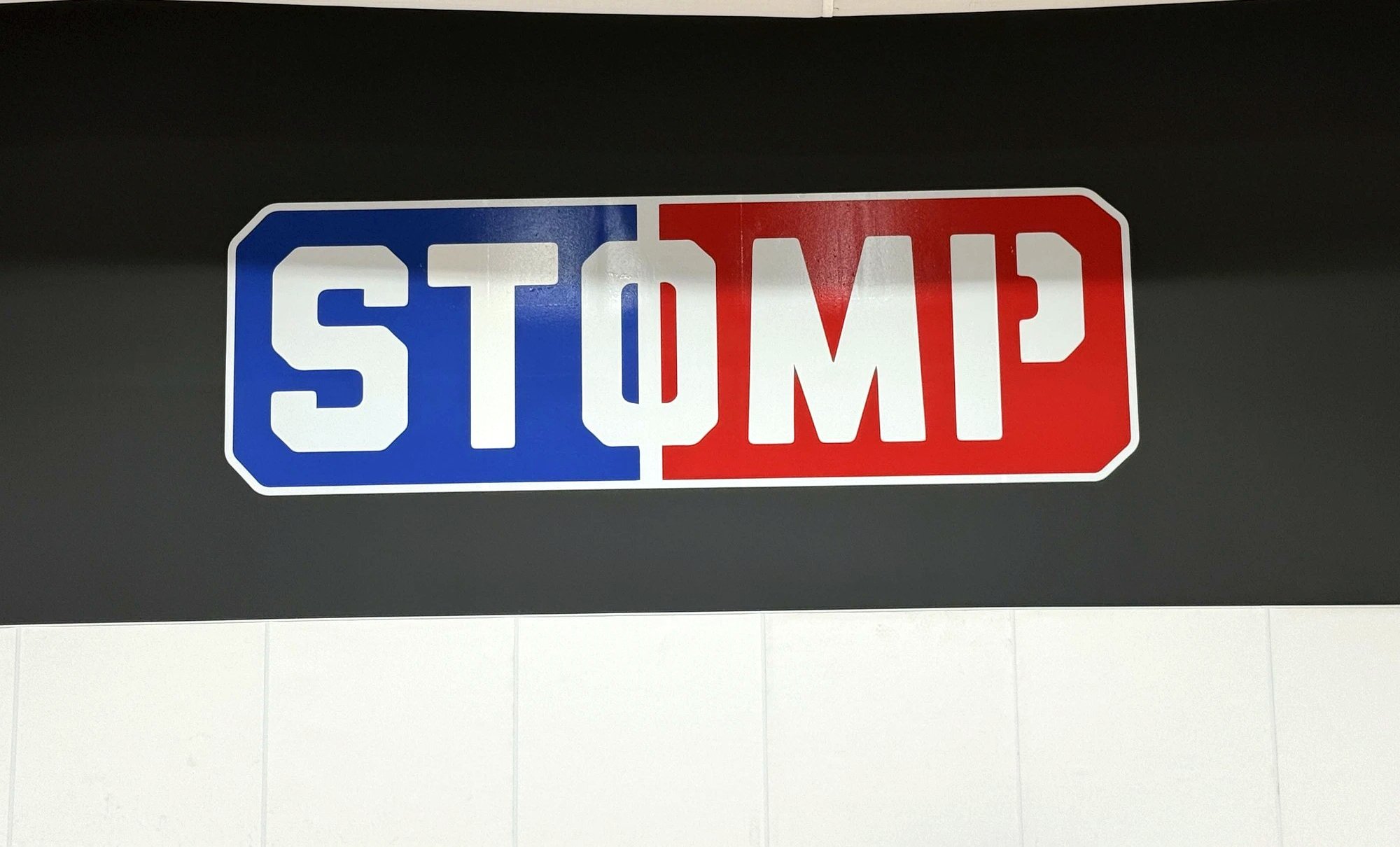 STOMP logo sign inside the private STOMP Gym in Englewood, CO
